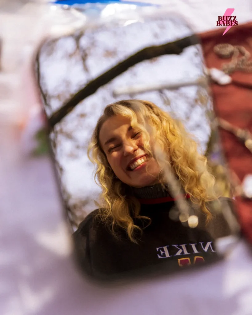 Person smiling at a Buzz Babes outdoor community event