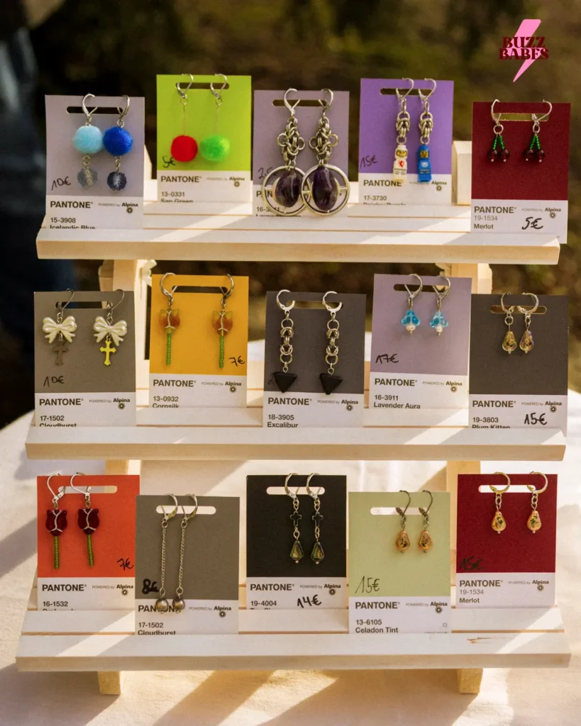 Handmade earrings displayed at a Buzz Babes flea market event
