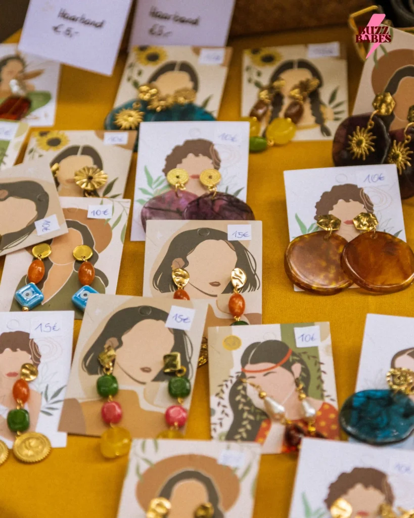 Handmade earrings displayed at a Buzz Babes market